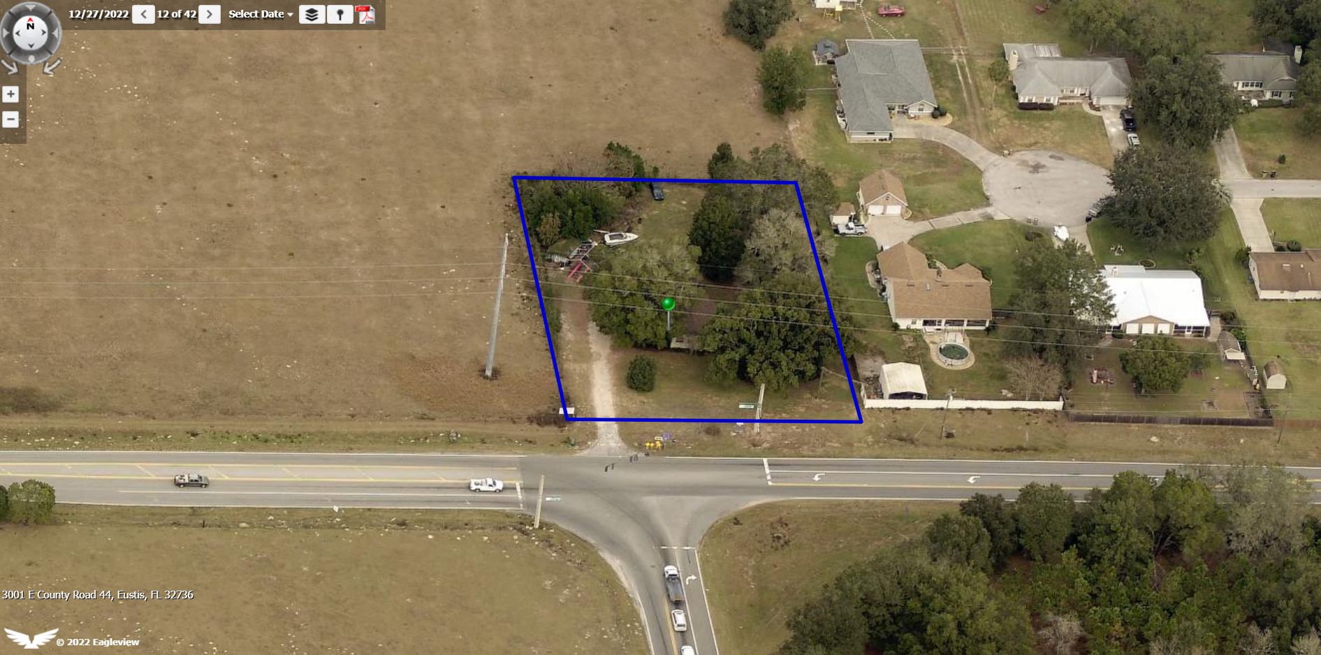 Aerial view of the corner parcel at 3001 E County Road 44 outlined at the signalized intersection of CR 44 and CR 44A in Eustis, Florida